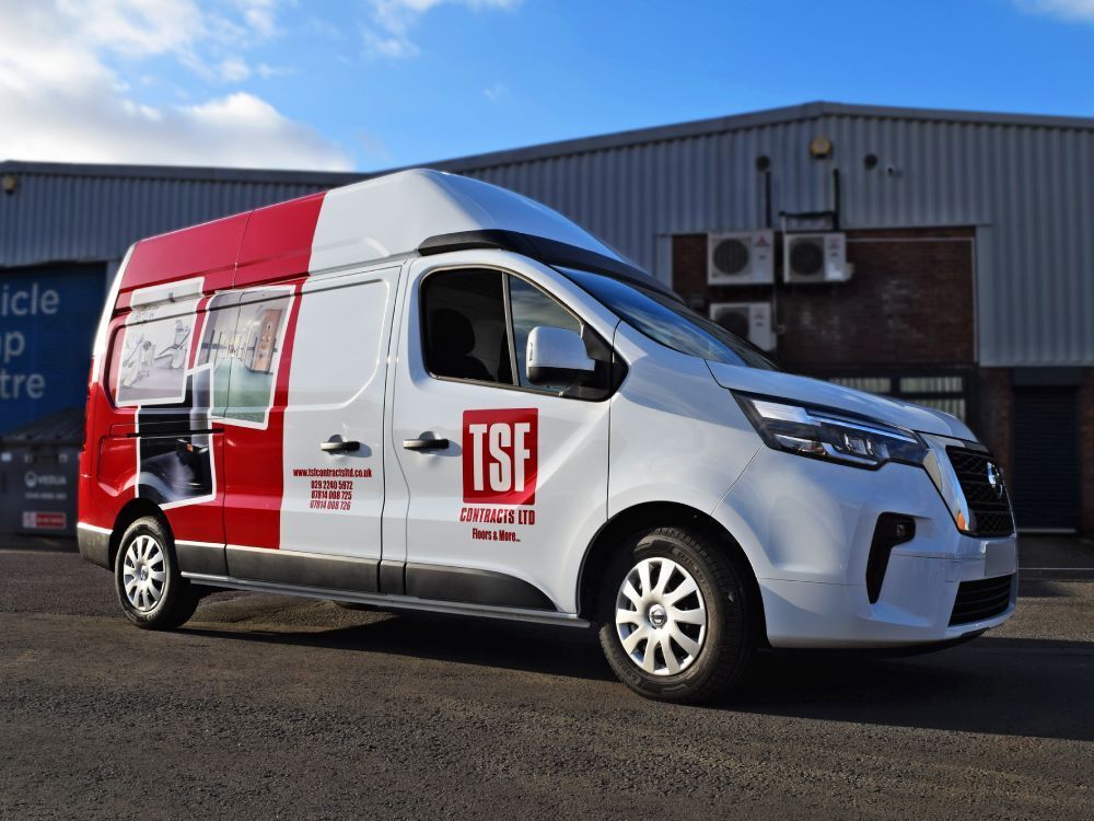 Partial company branded van livery on Nissan Primastar.