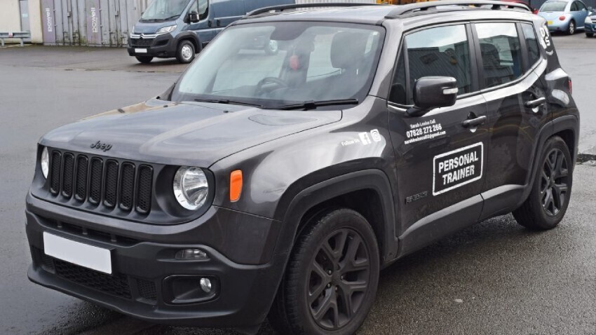 Grey company Jeep with white branded vehicle graphics installed.