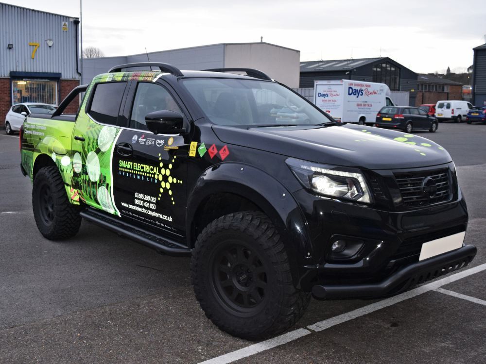 Green reflective digital print graphics on company Nissan Navara.