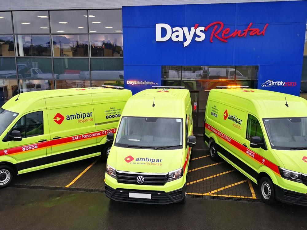 Fleet of Ambipar Response Volkswagen Crafter vans with matching yellow vehicle wraps and graphics parked outside Days Rental in Cardiff.