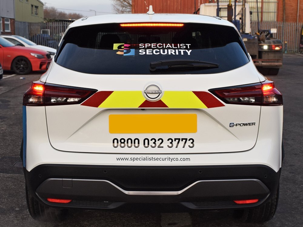 Safety chevron markings and branded vinyl graphics on rear of company Nissan Juke.