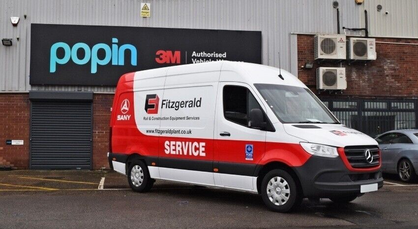 Branded partial vehicle wrap and vinyl graphics newly installed on company Mercedes Sprinter van.