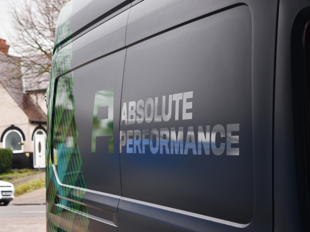 Company branded vehicle graphics installed on rear of Ford Transit van.