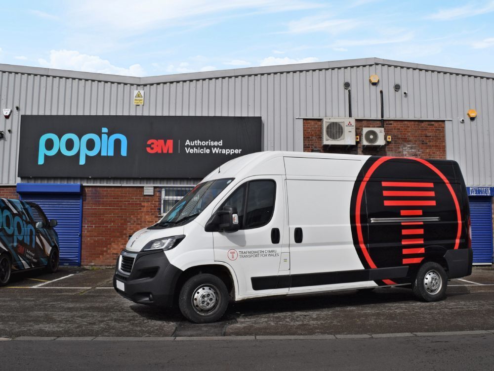 Company branded rear partial wrap and vinyl graphics on Peugeot Boxer van.