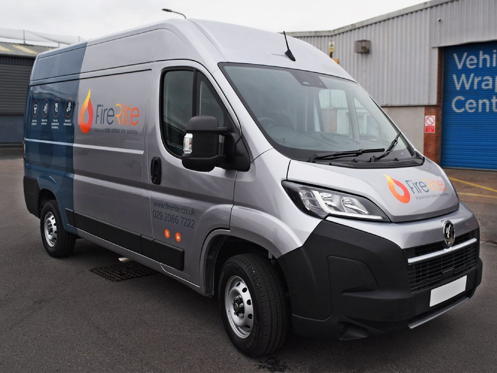 Silver company Vauxhall Movano with branded vinyl graphics and partial rear vehicle wrap.