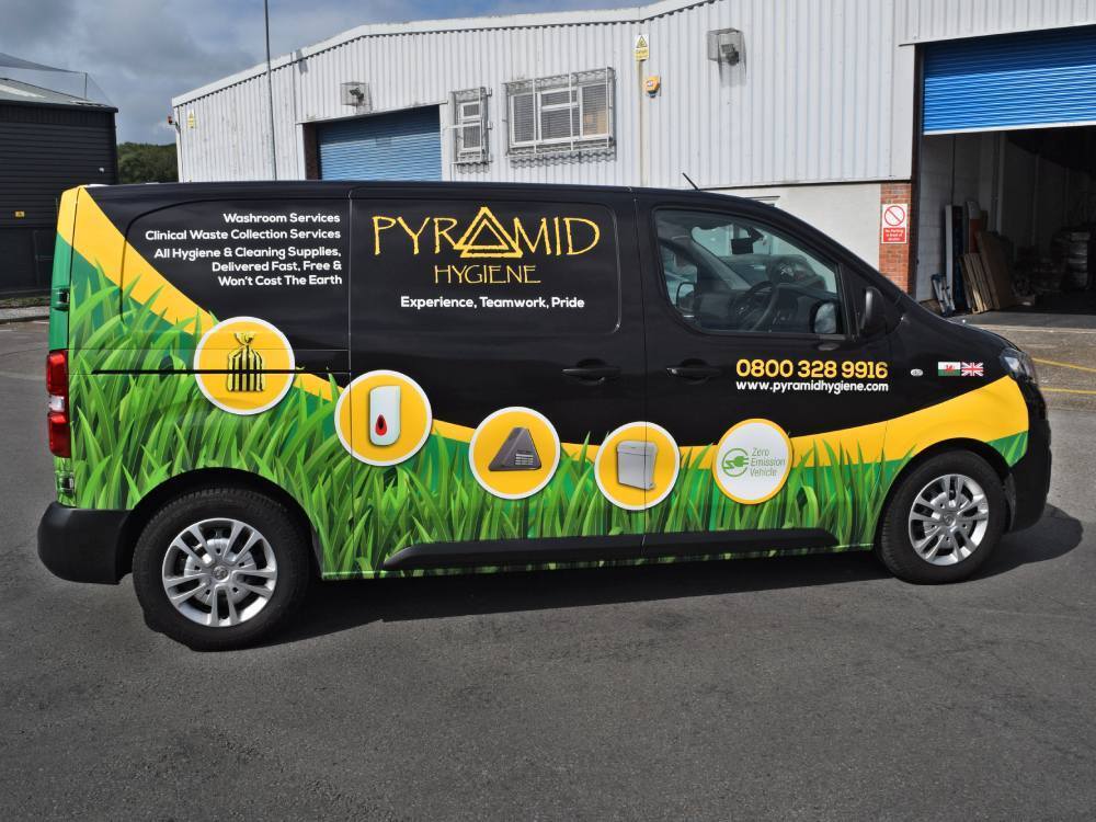 Company branded black green and yellow van wrap on Vauxhall Vivaro.
