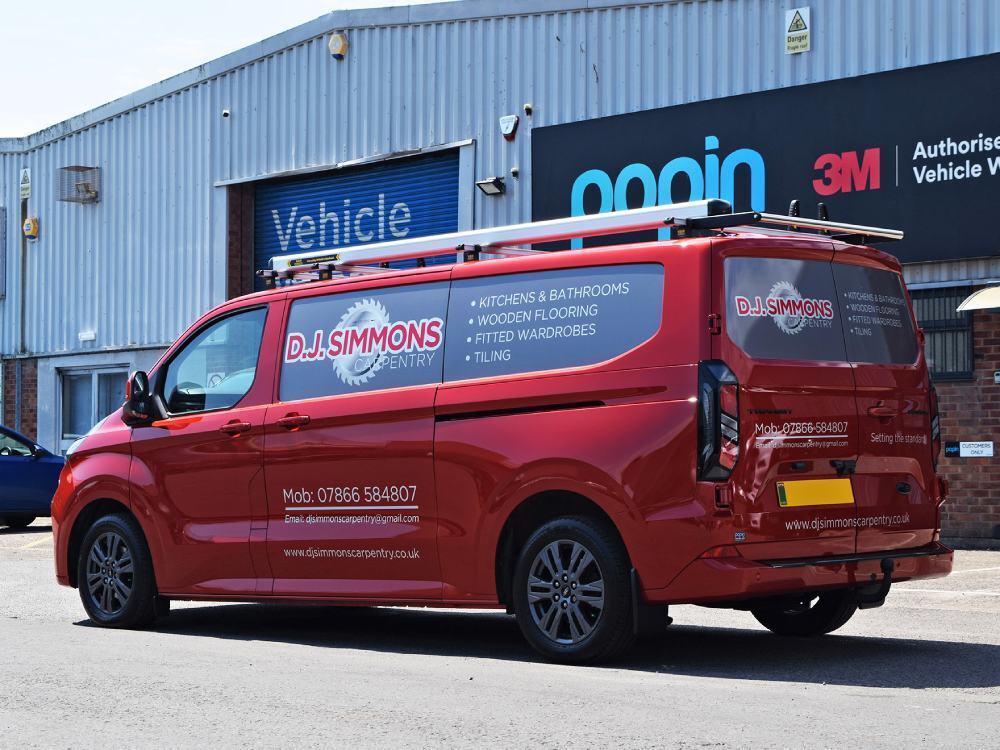 Branded infill panel graphics on a red Ford Transit Custom van.