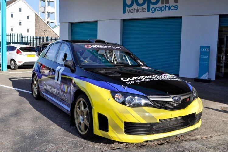 Motorsport wrap and race graphics on a Subaru Impreza B13 rally car outside Popin in Cardiff.