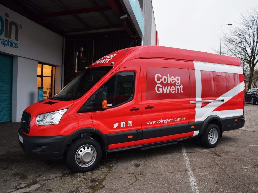 Red branded vehicle wrap on Coleg Gwent Ford Transit van.