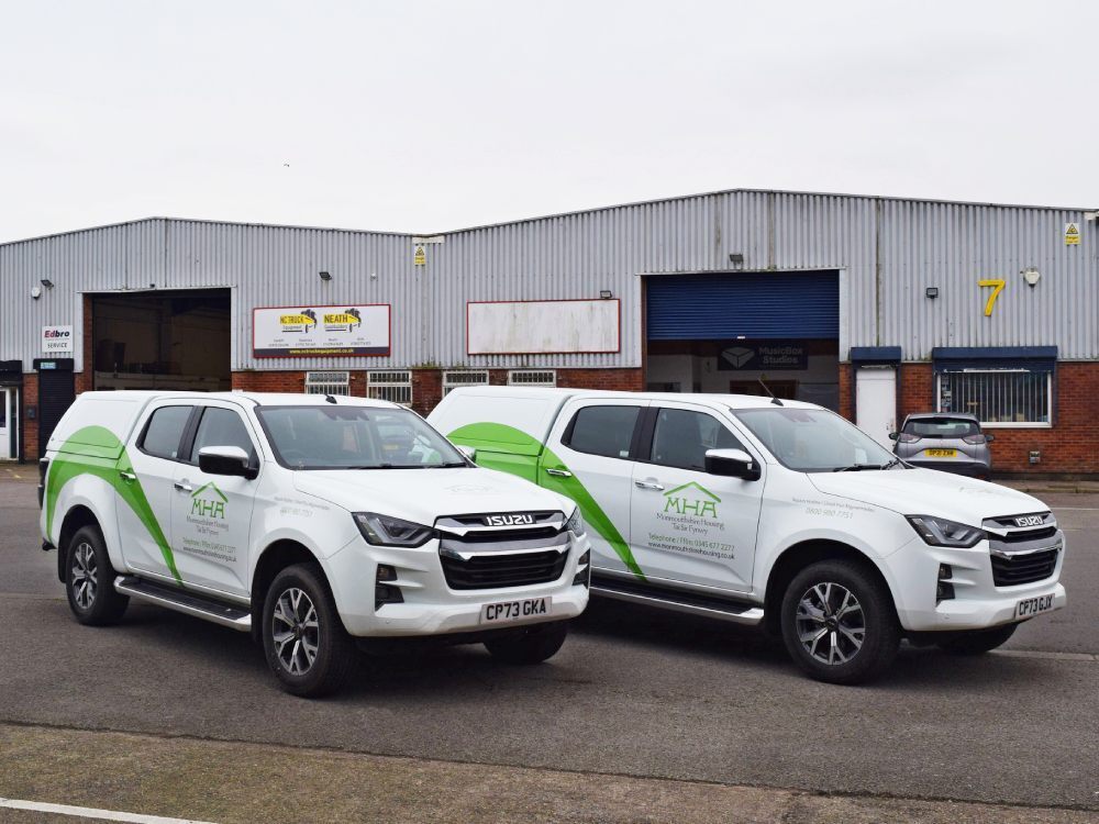Matching branded vehicle graphics on company vans.