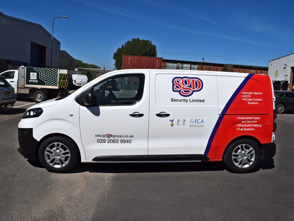 White Vauxhall Vivaro van with partial wrap and vinyl graphics.
