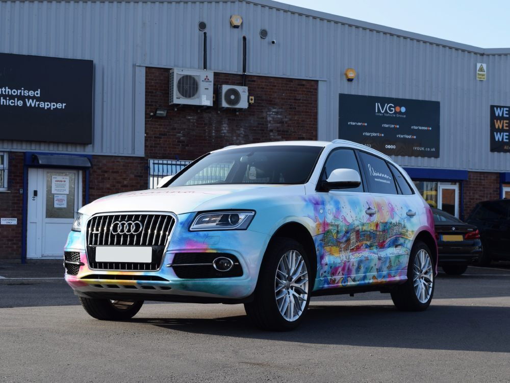 Audi Q5 company car with branded vehicle wrap.