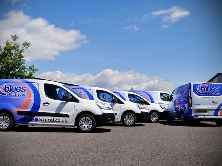 Fleet of company vans with identical branded vehicle wraps and graphics.