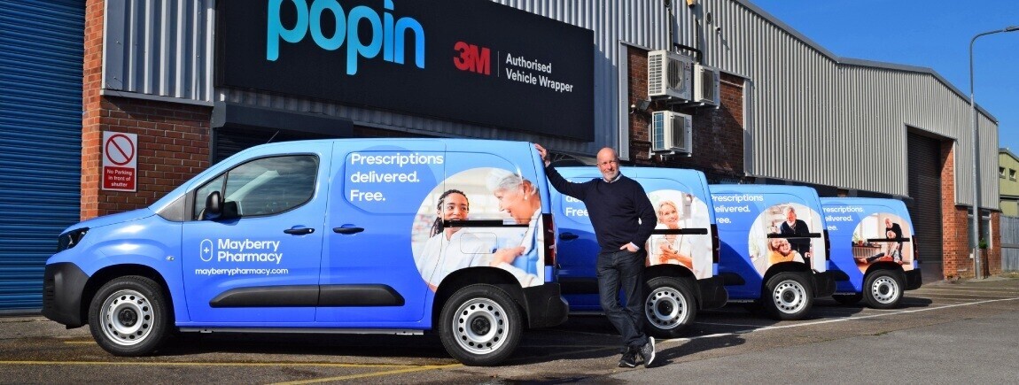 New vehicle wraps on a fleet of company vans outside Popin Graphics in Cardiff.