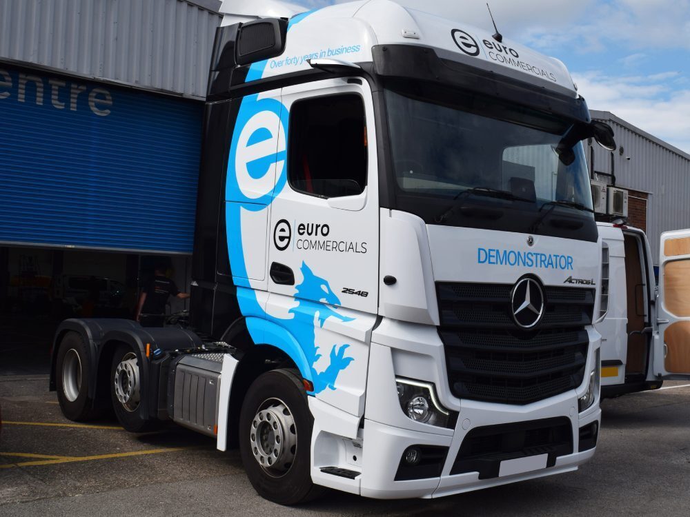 Vehicle wraps newly installed on a Mercedes lorry cab.
