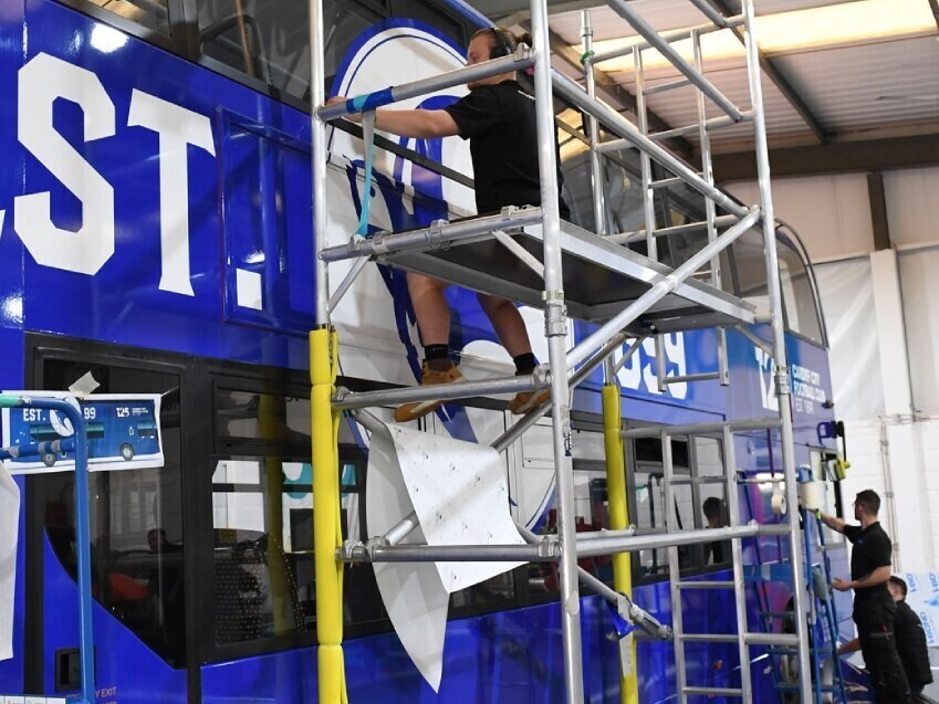 Vehicle wrap and vinyl graphics being installed on a bus at Popin in Cardiff.