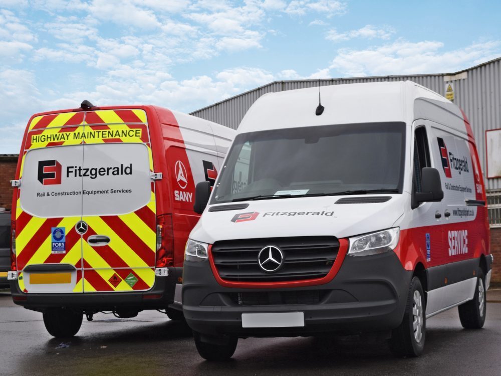 Mercedes Sprinter vans with branded vehicle wraps and safety chevron vinyl graphics.