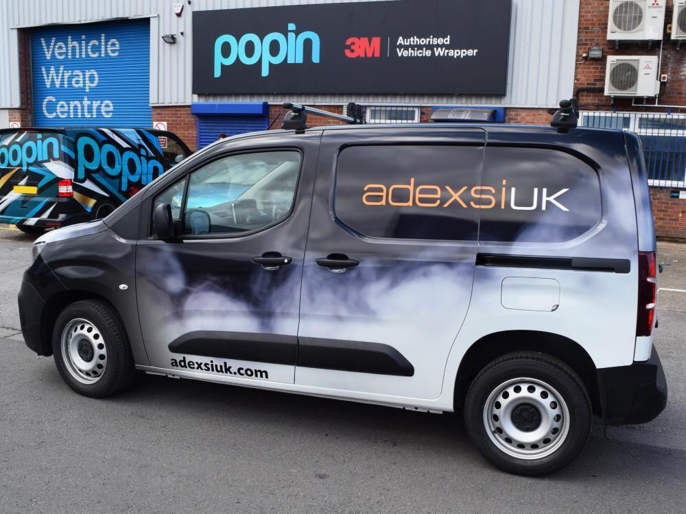 Company branded vehicle wrap on Peugeot Partner van.