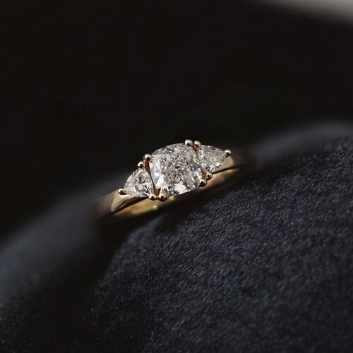Cushion and trilliant cut trilogy ring