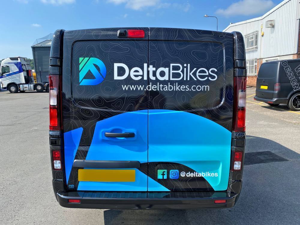 Vehicle livery on rear end of Renault Trafic company van.