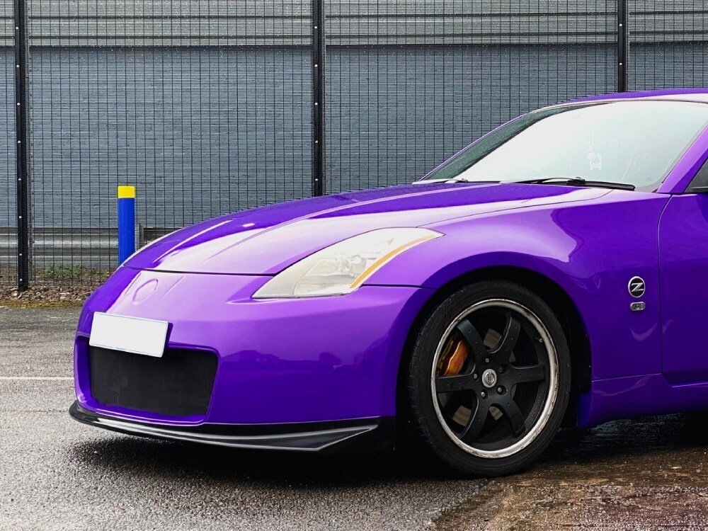 Purple motorsport livery on front end of a Nissan 350Z sports car