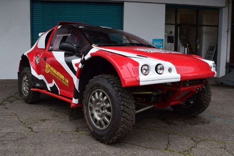 Peugeot 206 rally car with red, white and black motorsport wrap and graphics outside Popin in Cardiff.