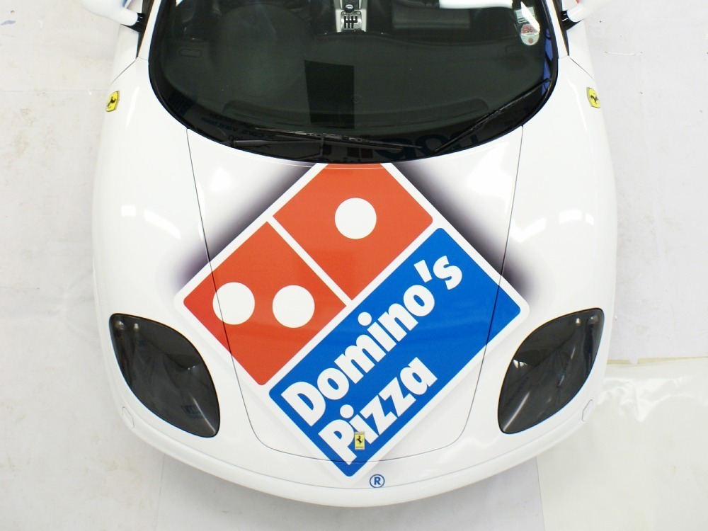 Domino's Pizza car logo graphic on the bonnet of a white Ferrari 360 Spider.