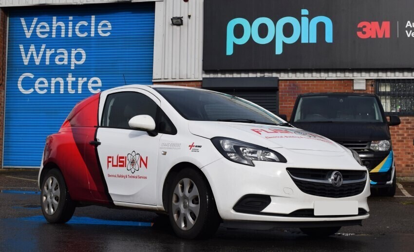 Partial wrap and branded vehicle graphics on a white company car outside Popin in Cardiff.