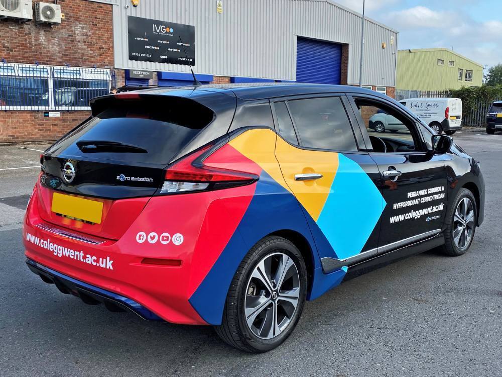 Company branded rear partial wrap and graphics on Nissan Leaf.
