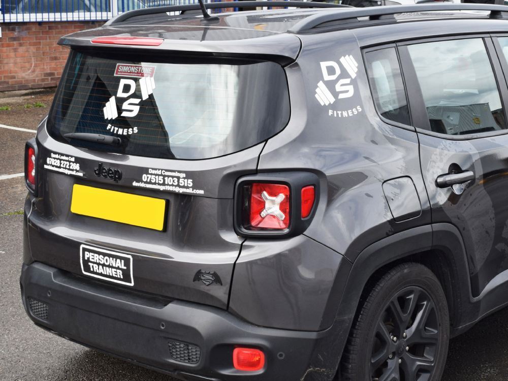 Company branded vinyl graphics on rear of grey Jeep.