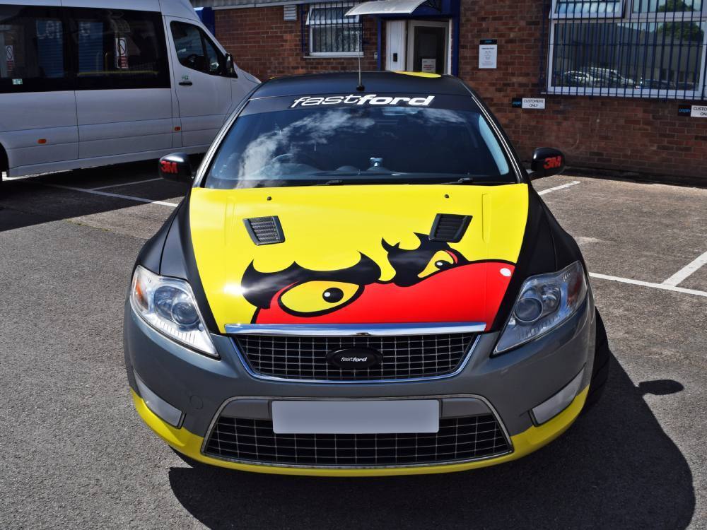 Ford Mondeo company car with commercial graphics on bonnet.
