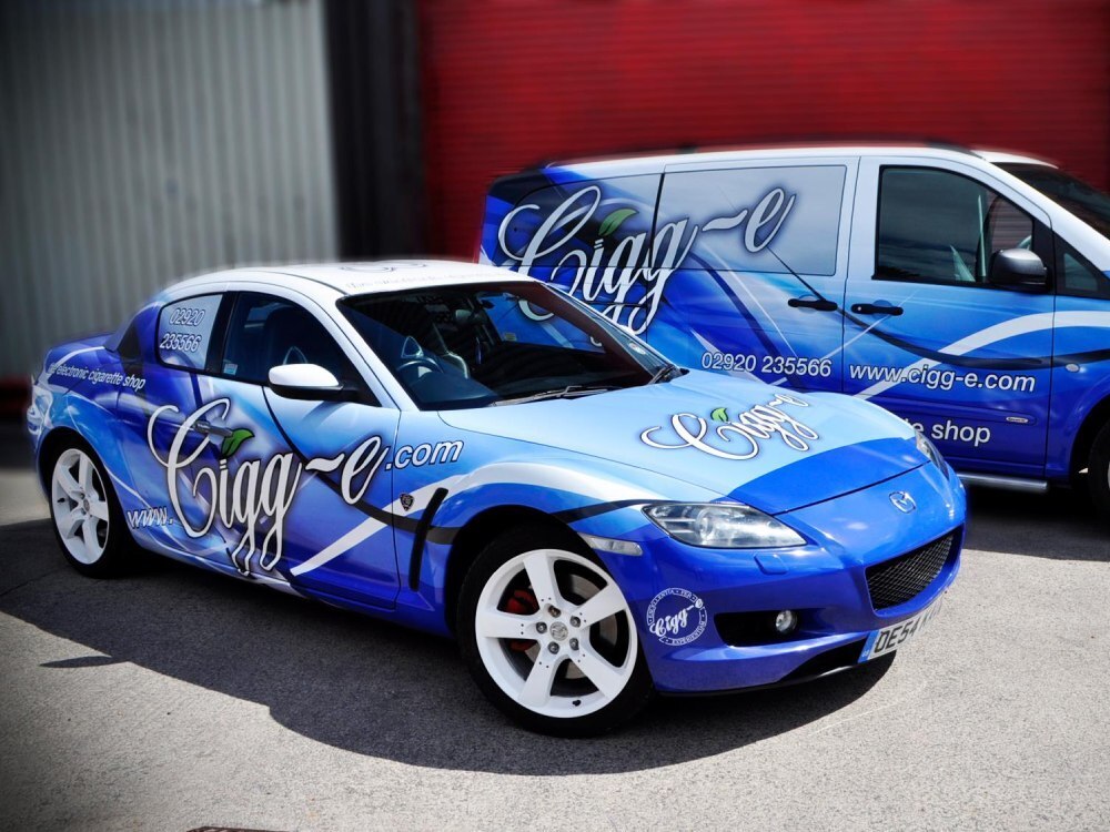 Company car and van in fleet with matching branded vehicle vinyl wraps.