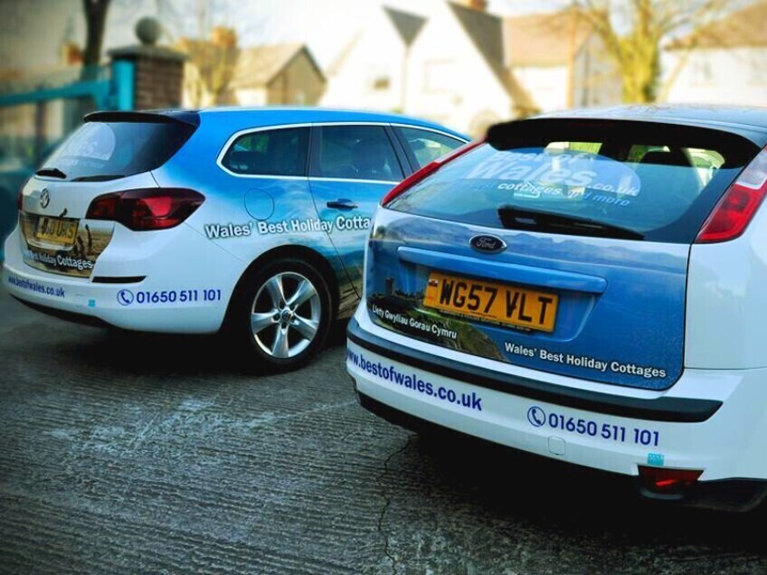 Fleet of company cars with matching branded vehicle vinyl wraps.