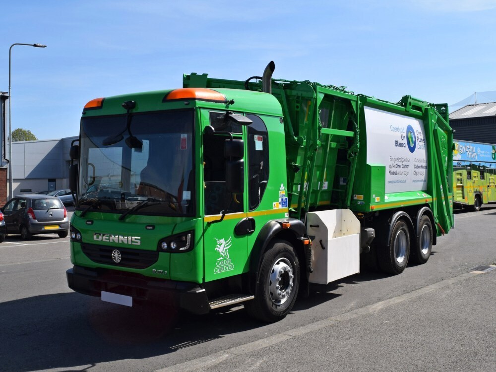 Green vehicle wrap on Dennis truck.