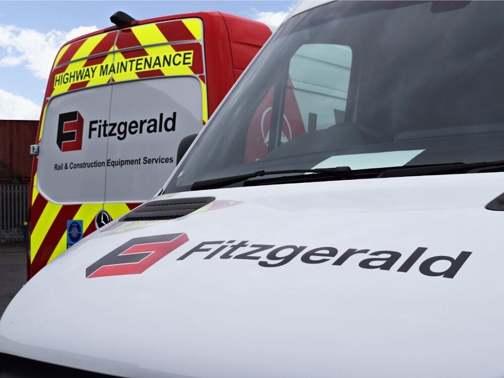 Vehicle vinyl graphics and Chapter 8 safety chevron markings on Mercedes Sprinter vans.