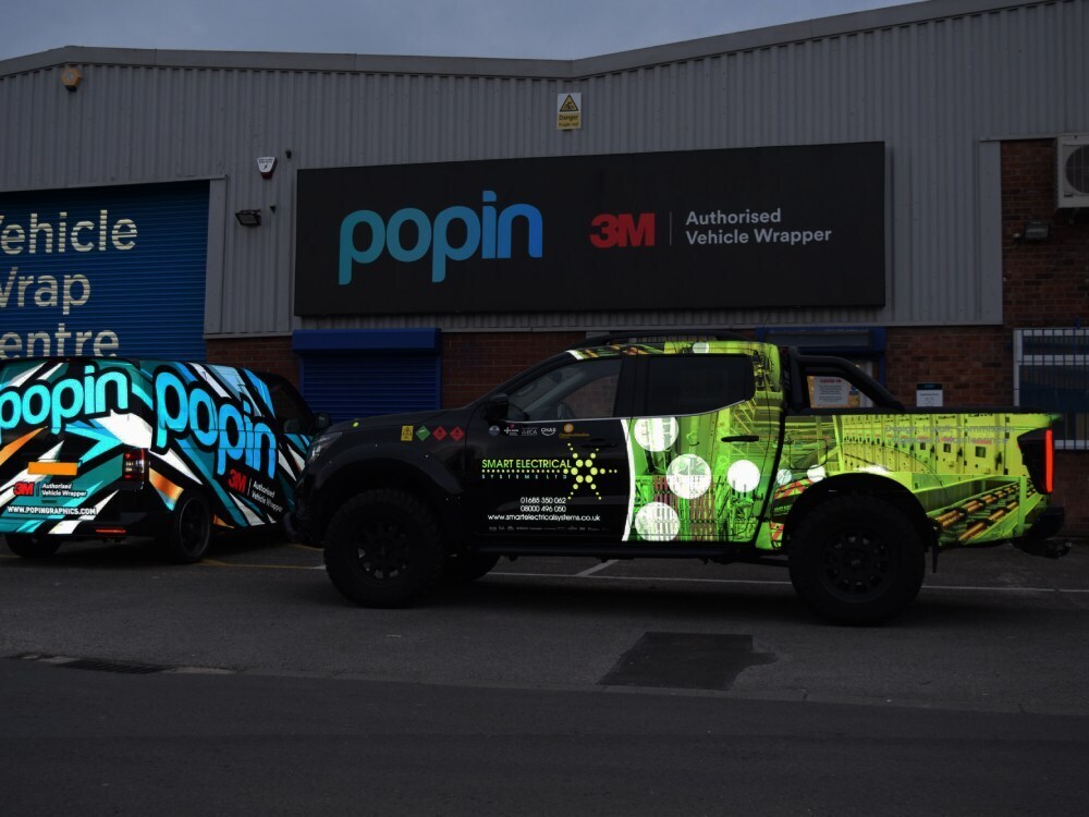 Reflective vehicle vinyl wrap on a company SUV.