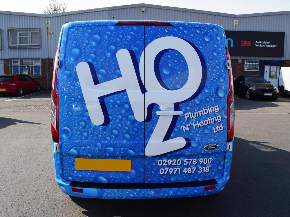 vehicle wrap with water droplets design on rear of Ford Transit Custom van.