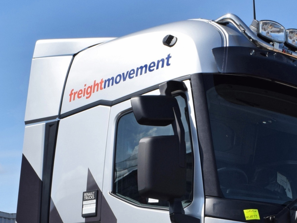 Vehicle vinyl graphics on the front cab of a Renault lorry.