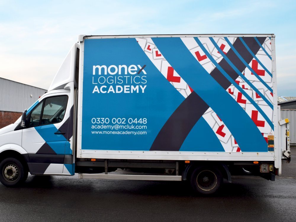 Monex Academy branded vehicle wrap on Mercedes Sprinter Box van.