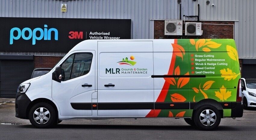 Company branded partial vehicle wrap on white Renault Master van.