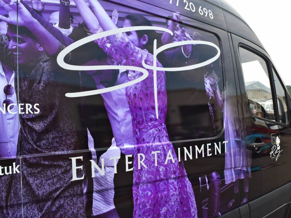 Close up of purple and black company van wrap on Mercedes Sprinter L3H2.