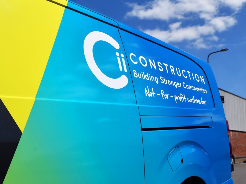 Bold blue and yellow van wrap on company Vauxhall Vivaro.