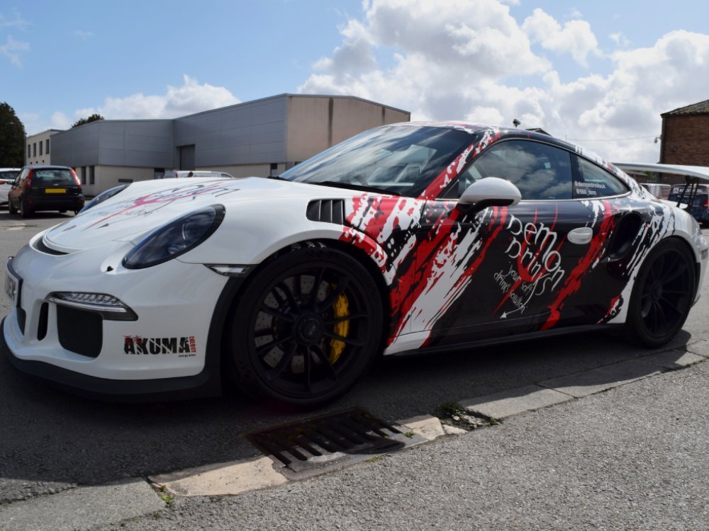 Motorsport livery and race graphics on a white Porsche GT3 RS