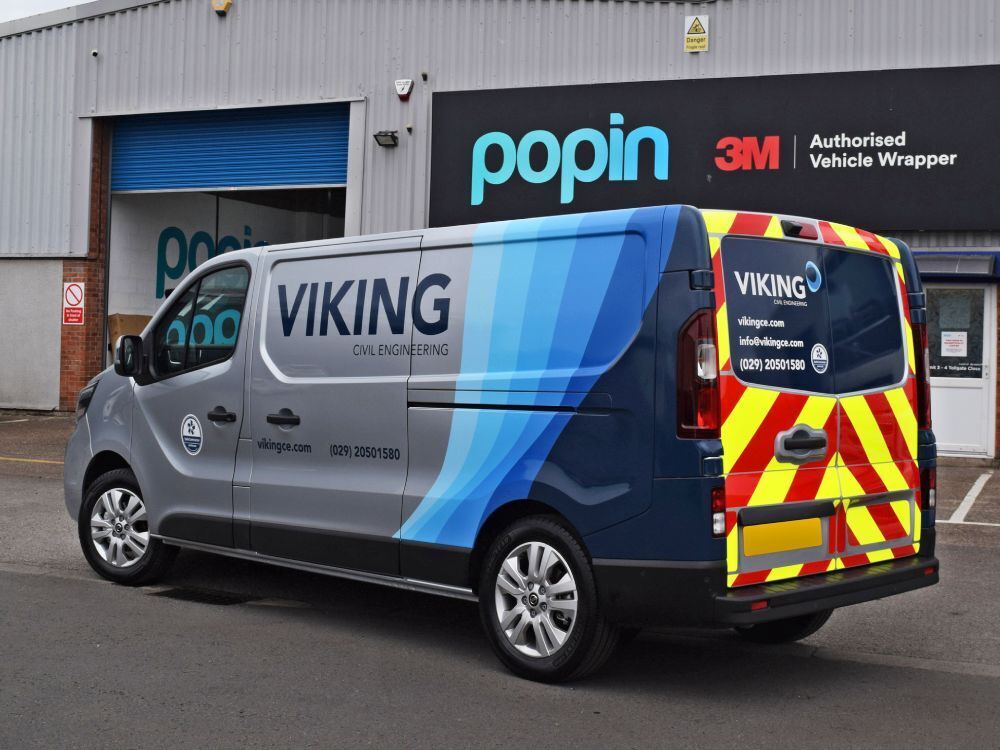 Branded van wrap with rear safety chevron graphics on Nissan NV300 outside Popin in Cardiff..