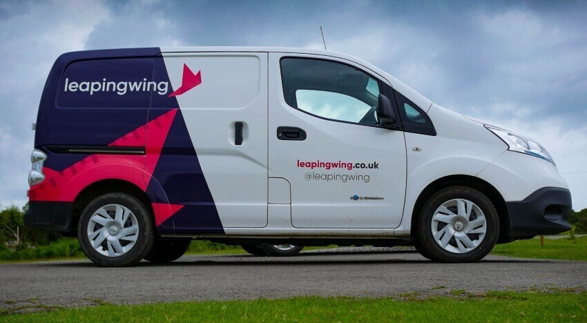 Leaping Wing partial company branded van wrap on a Nissan enV200.