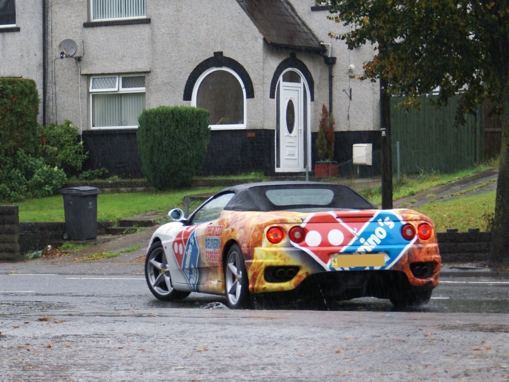 Ferrari 360 Spider with Domino's Pizza wrap driving in Cardiff.