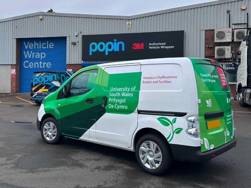 University of South Wales branded van livery on Nissan enV200 outside Popin in Cardiff.