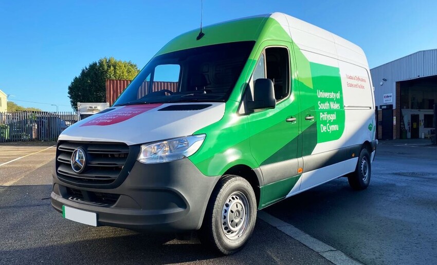 Electric Mercedes-Benz company van with University of South Wales branded vehicle wrap and graphics.