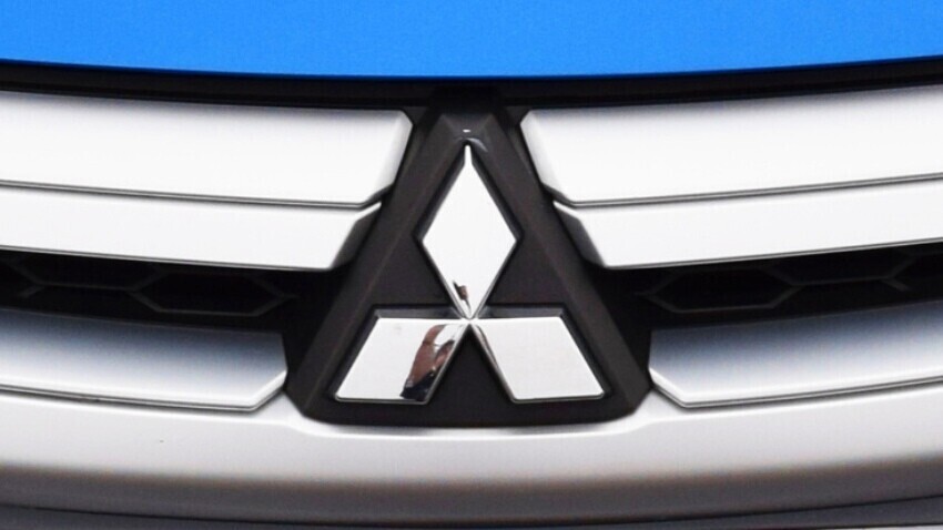Mitsubishi logo on a blue vehicle.