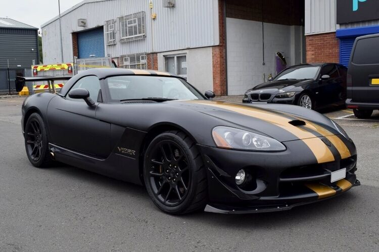 Matte black motorsport livery with two gold sport stripe graphics on Dodge Viper SRT10